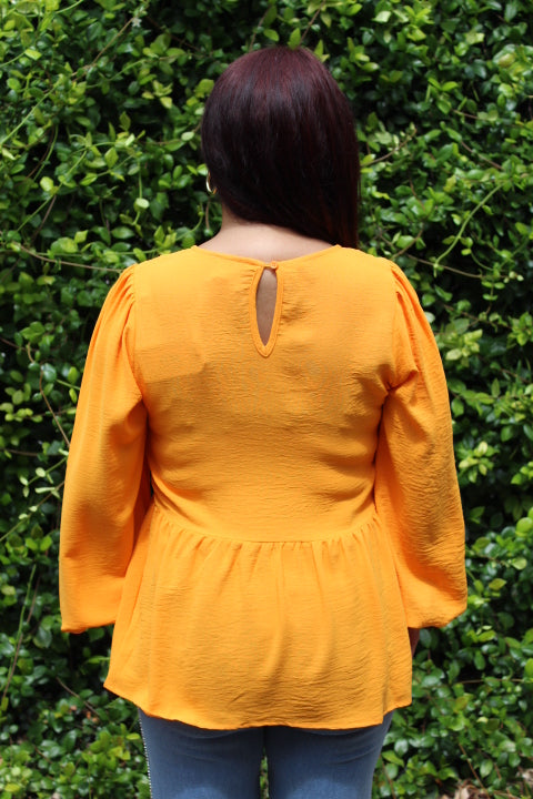 ORANGE RUFFLED HEM BLOUSE